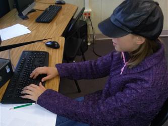 Student Typing on a Computer